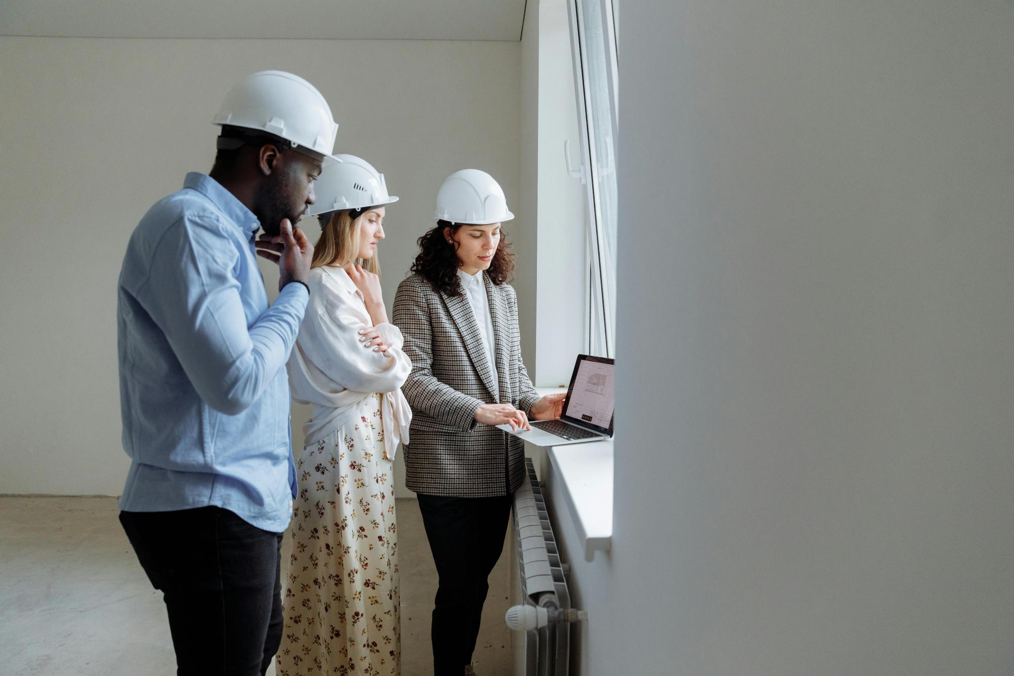People reviewing construction plans at a construction site.
