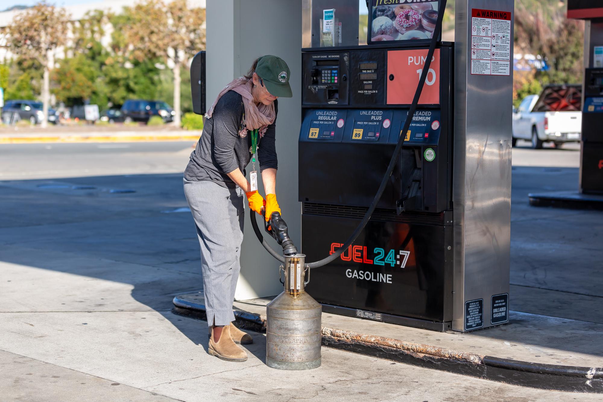 County of Marin Weights and Measures inspector testing the accuracy of a gasoline pump using a certified fuel measuring container.