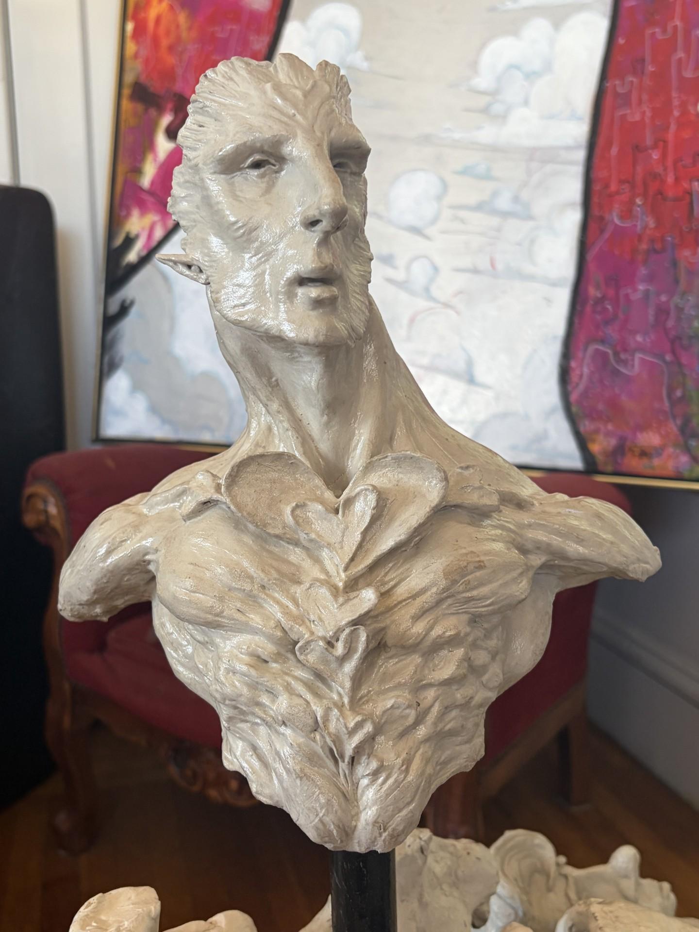 A sculpture of a man's upper body with hearts coming out of the chest