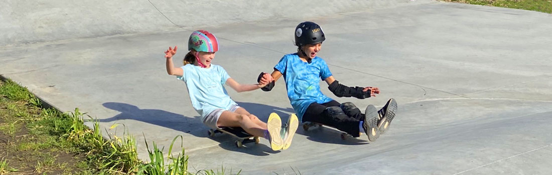 Two kids on skateboards.