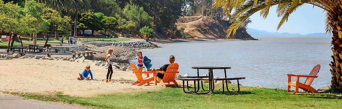 Family relaxing on the lawn at McNears Beach Park