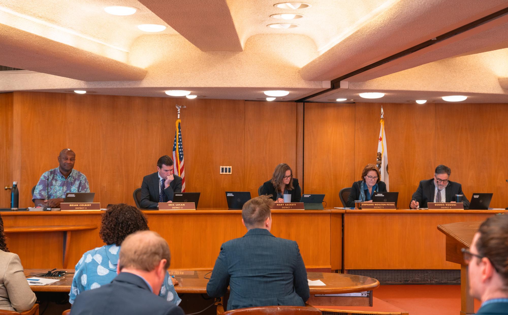 Board members seated at the board of chambers.